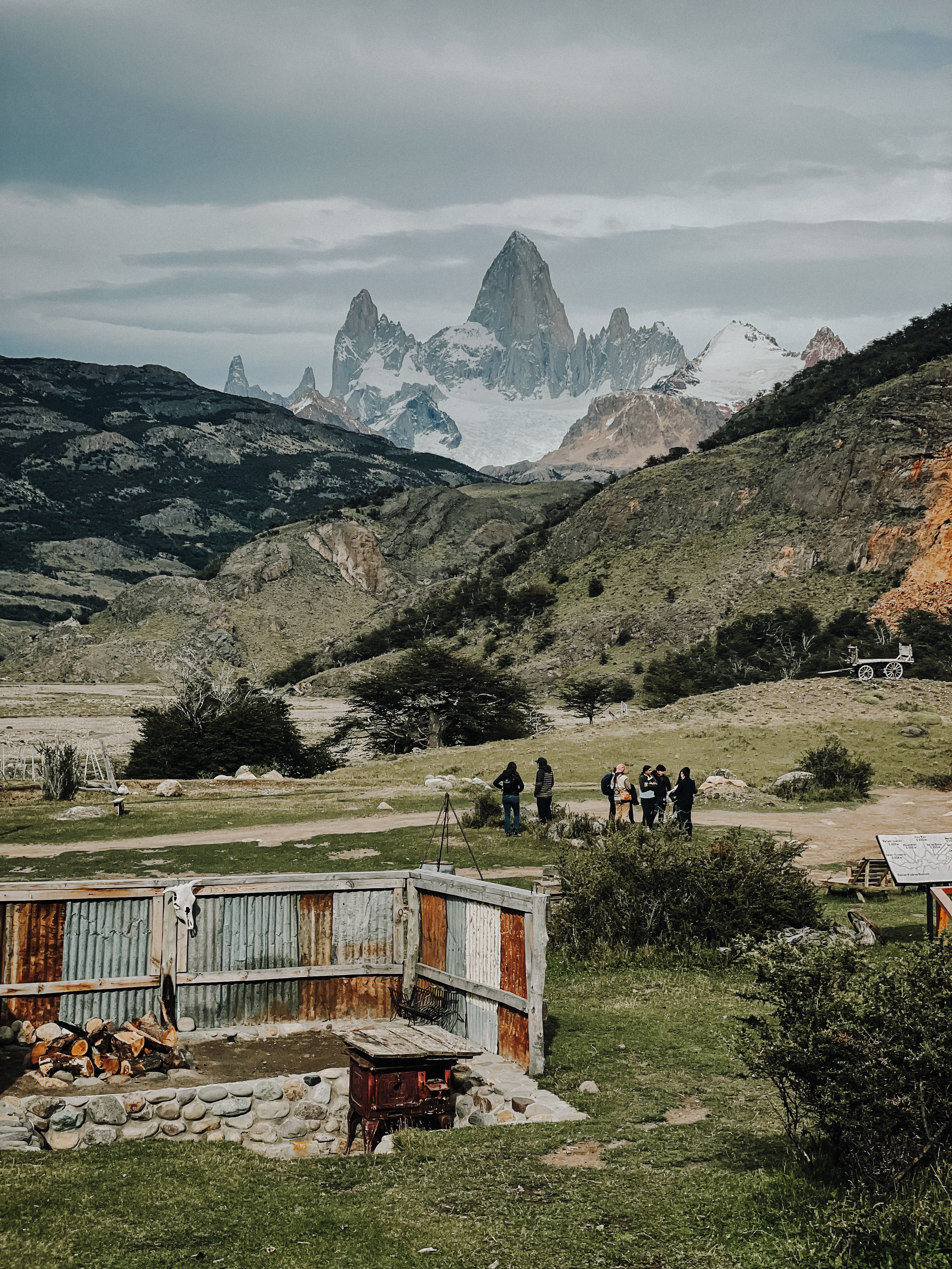 Picture of Mt Fitz Roy in Patagonia Argentina behind green hills and a horse ranch