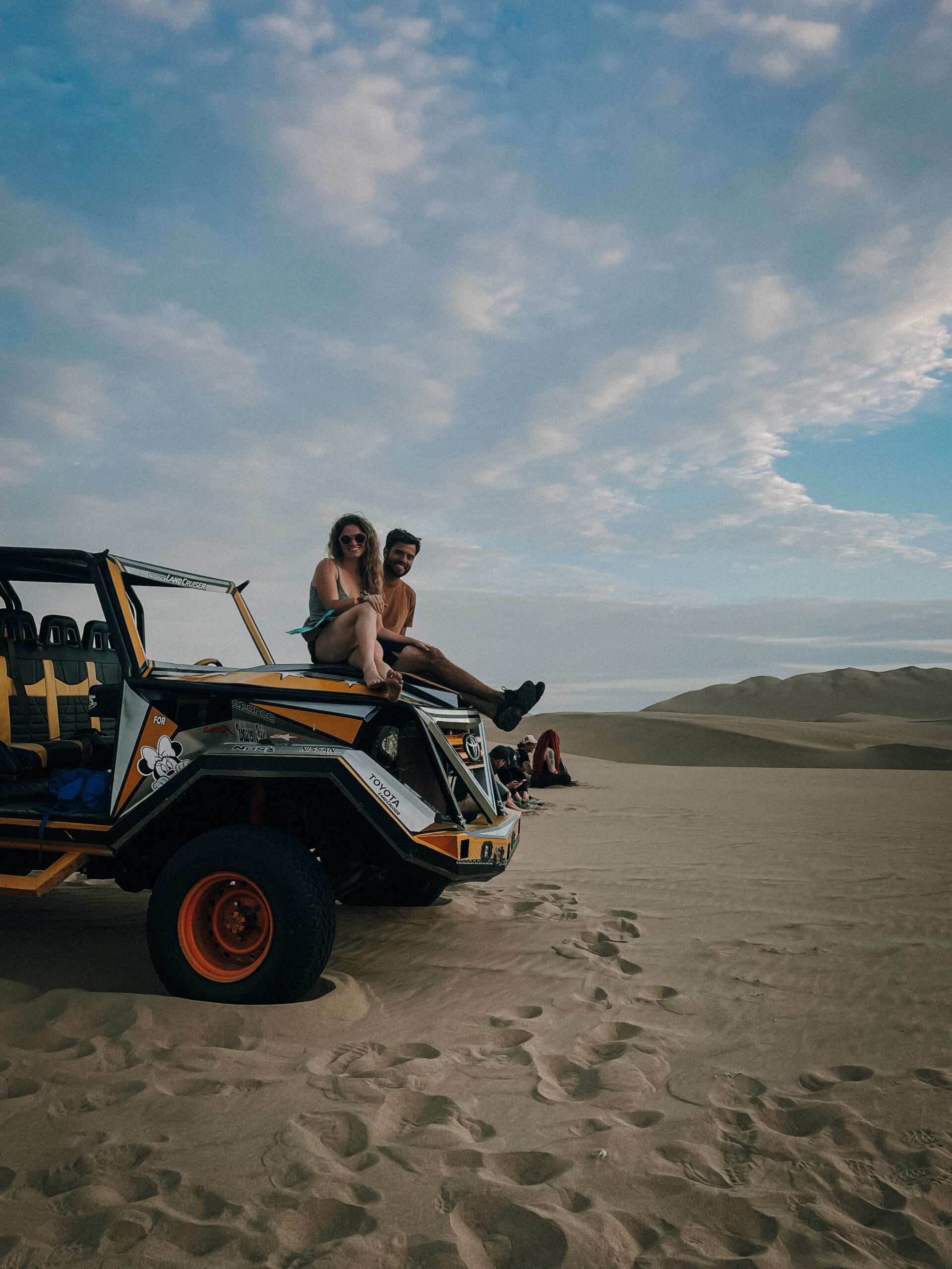 Me and James sitting on top of sand buggy during sunset during Huacachina sand buggy tour