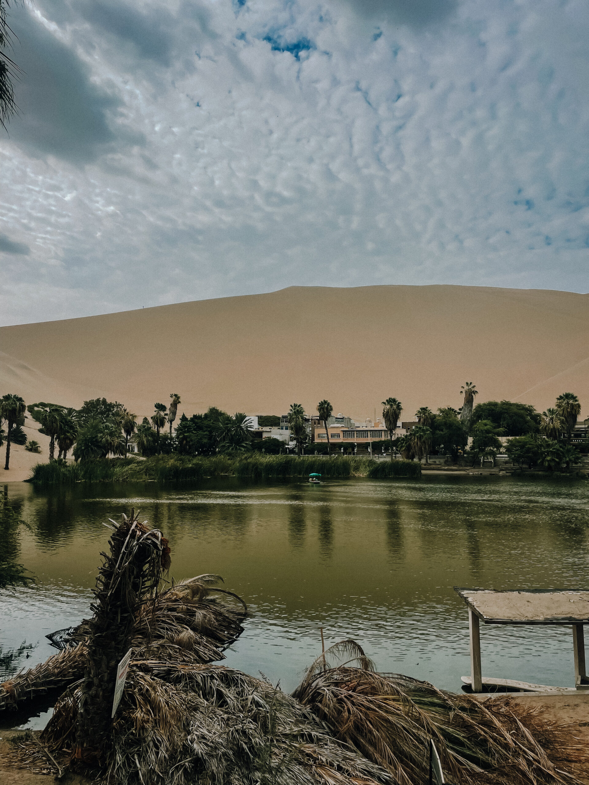 Huacachina sand dunes in Peru with lagoon in center