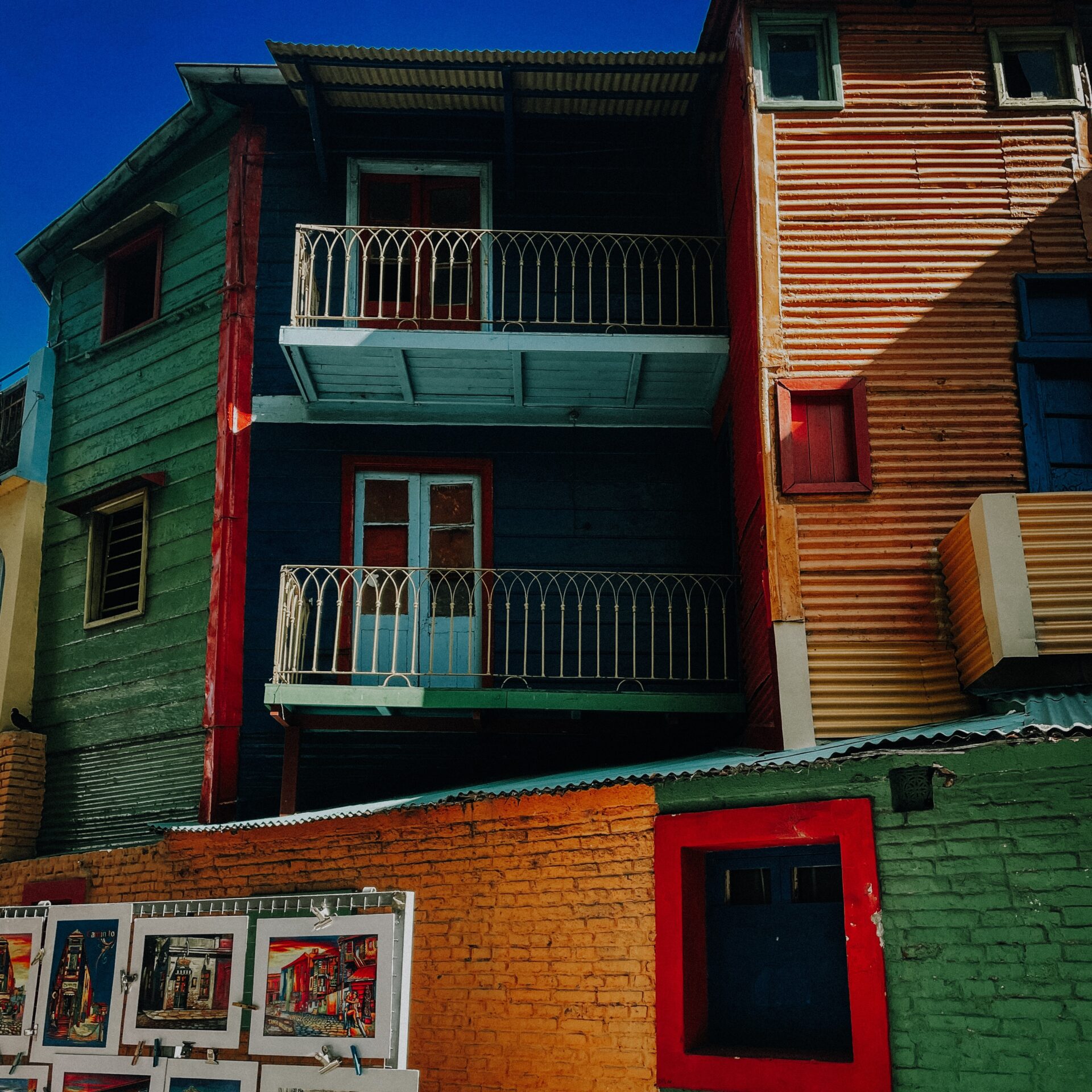 Colorful buildings in La Boca Buenos Aires with art street vendor