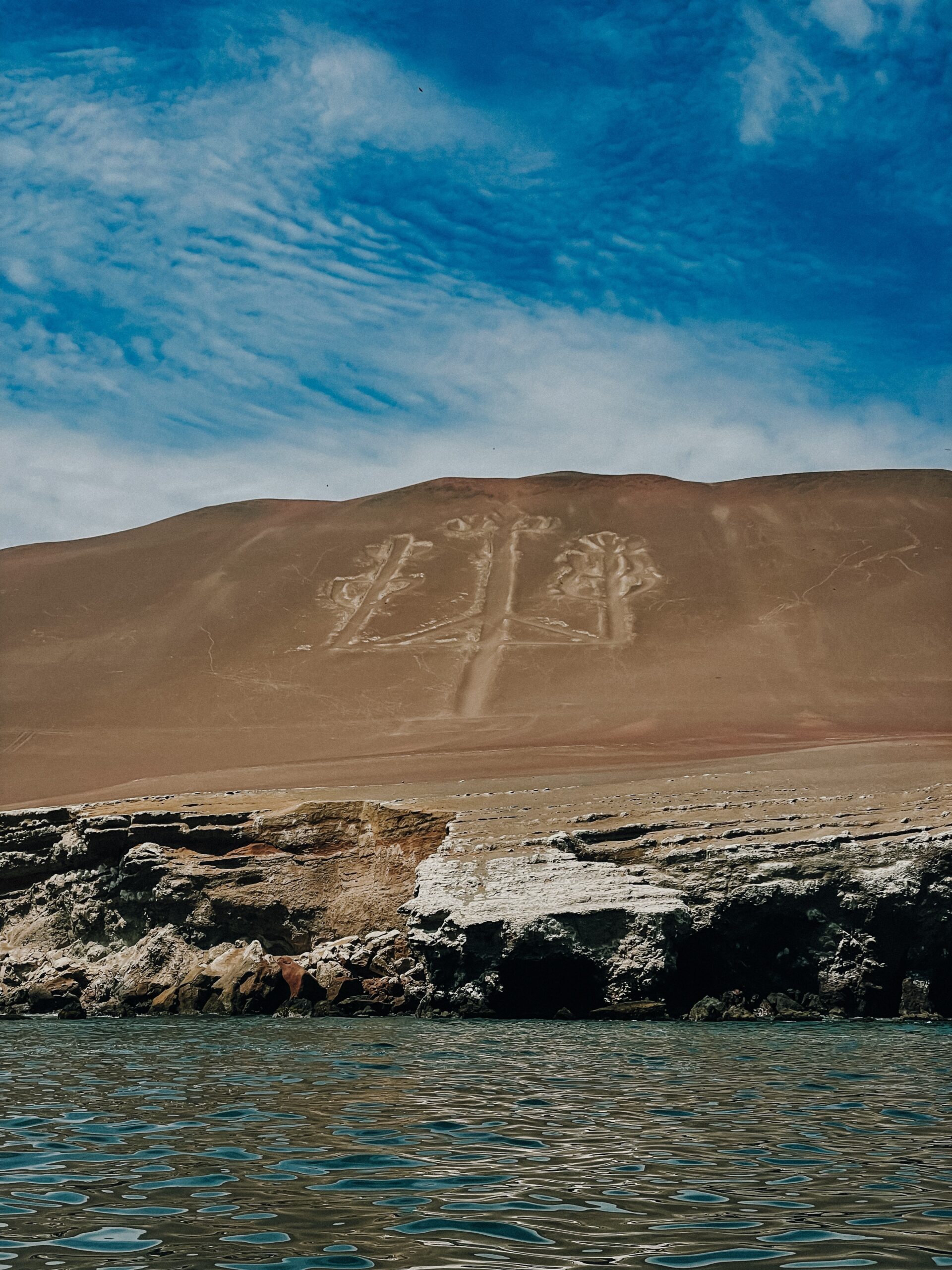 Trident-shaped craving in large rock formation during Ballestas Island Tour