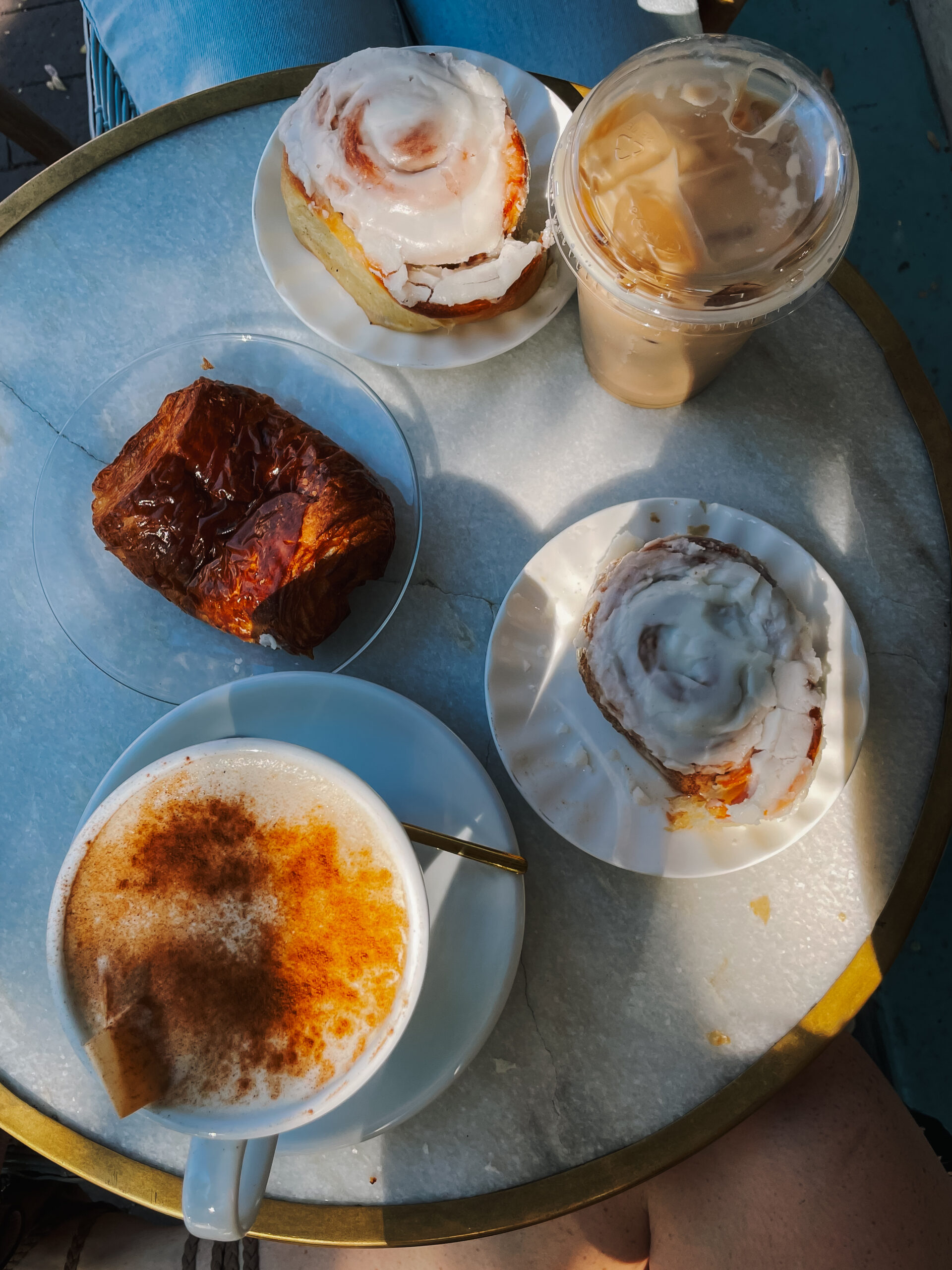 Table with coffe, a cup of tea and pastries