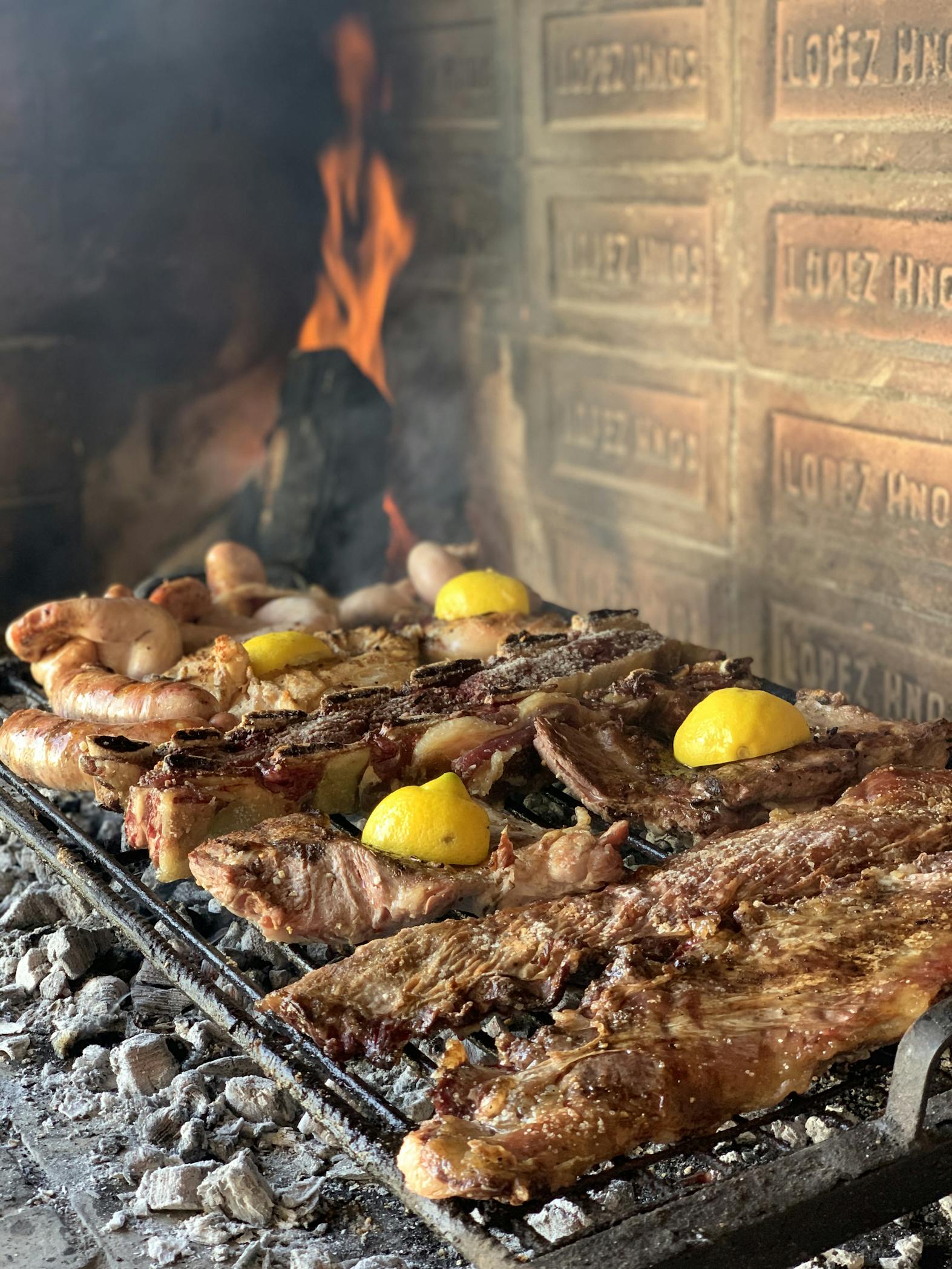 Savory Argentine asado with meat and lemon slices grilling on an open fire in Mendoza.