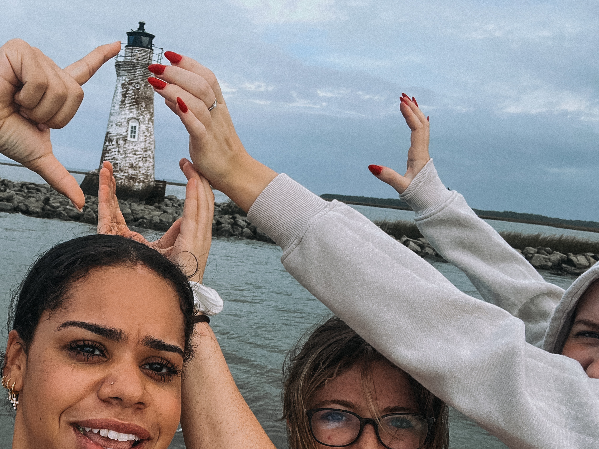 Unique things to do in savannah My friends and I taking a photo in front of lighthouse by Tybee ISland